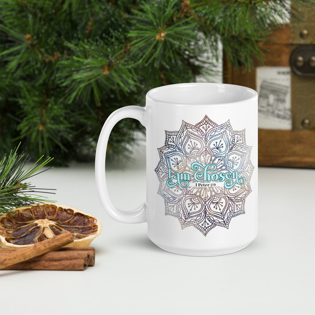 White glossy 15 oz mug with the I Am Chosen 1 Peter 2:9 design, handle on the left on a counter