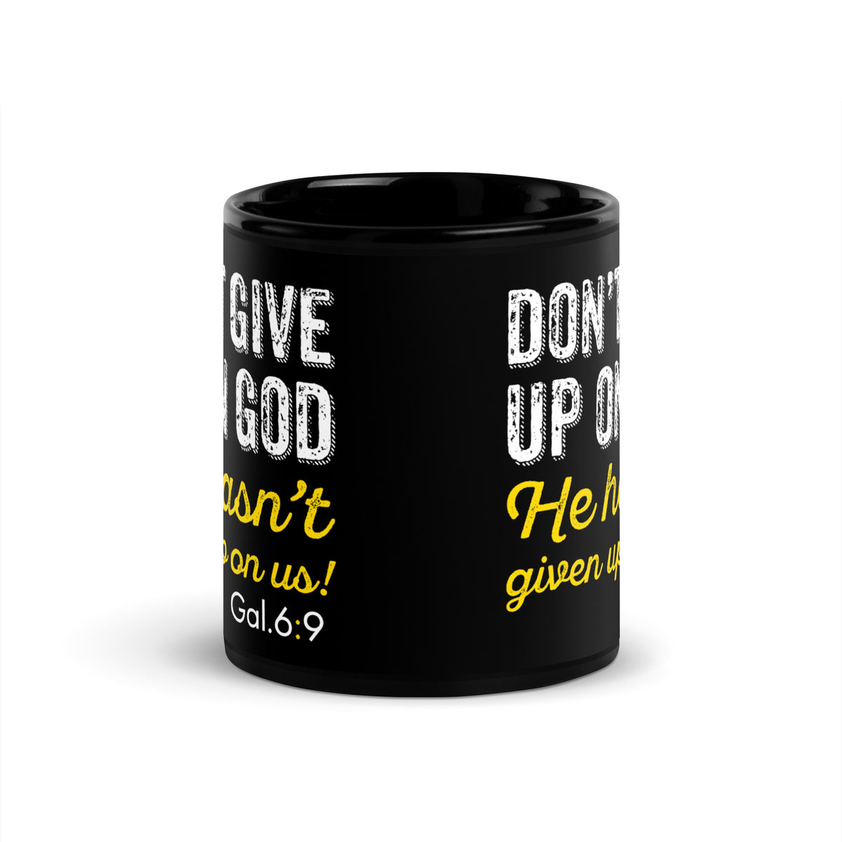 Side view of a black mug showing the repeated white and yellow Galatians 6:9 design