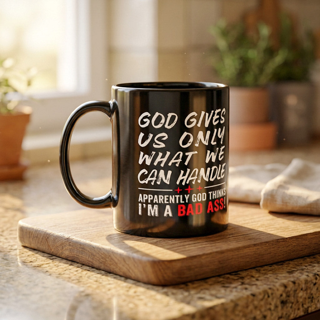 Black 15 oz mug God Gives Us Only What We Can Handle on a kitchen countertop handle on left