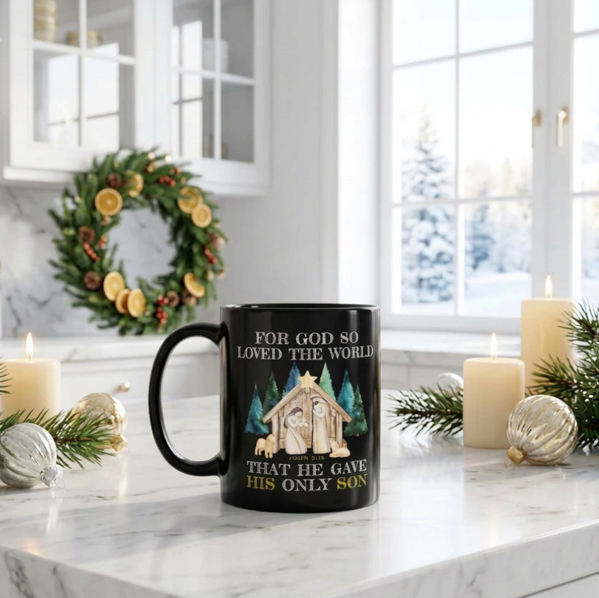 Black John 3:16 nativity mug on a kitchen island with evergreen branches, candles and a Christmas wreath, handle on the left