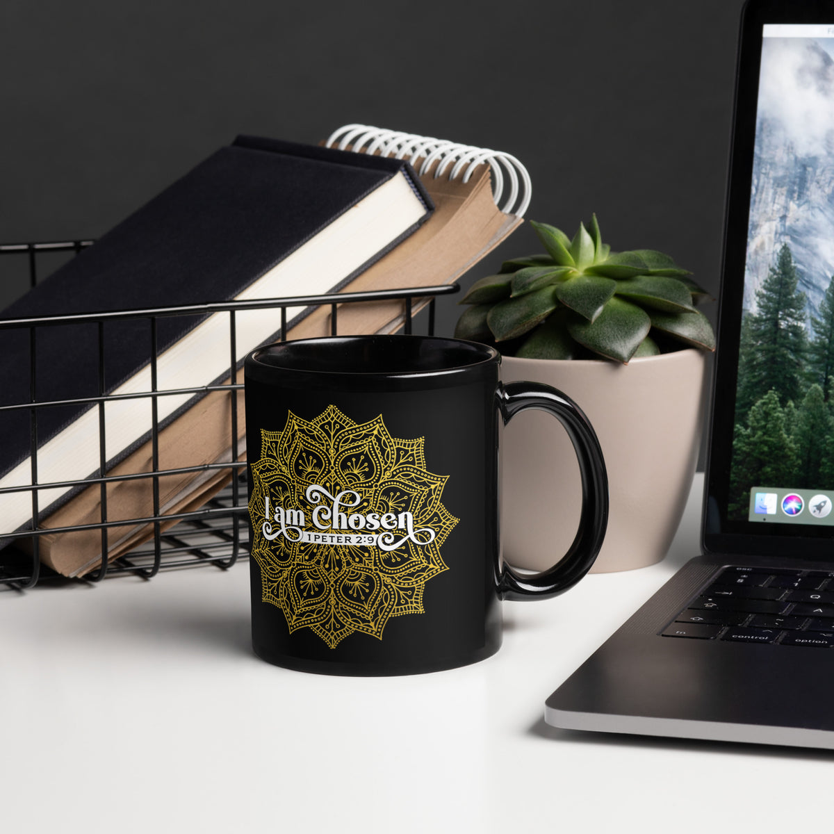 Black I Am Chosen 1 Peter 2:9 mug beside a laptop, notebooks and succulent, handle on right