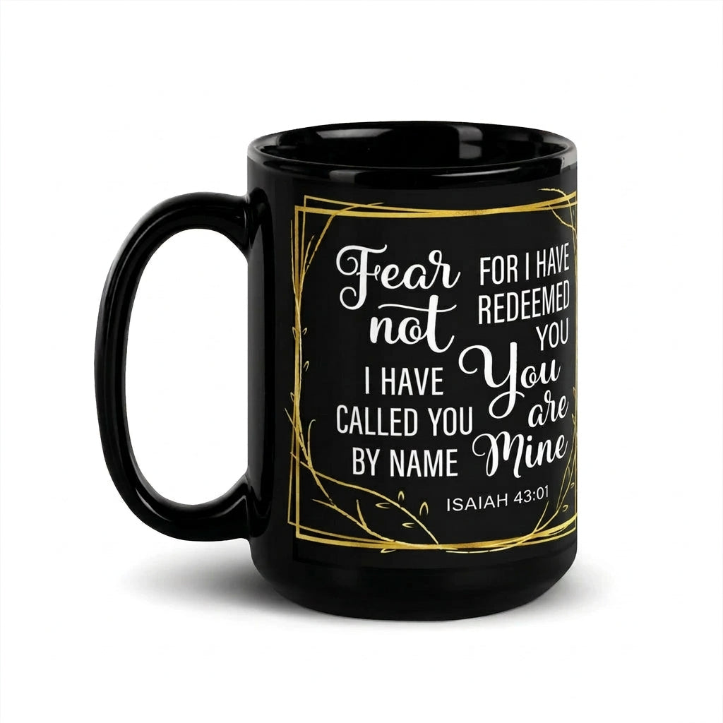 Black Fear Not Isaiah 43:1 mug with white lettering and a gold-colored leafy border, handle on left