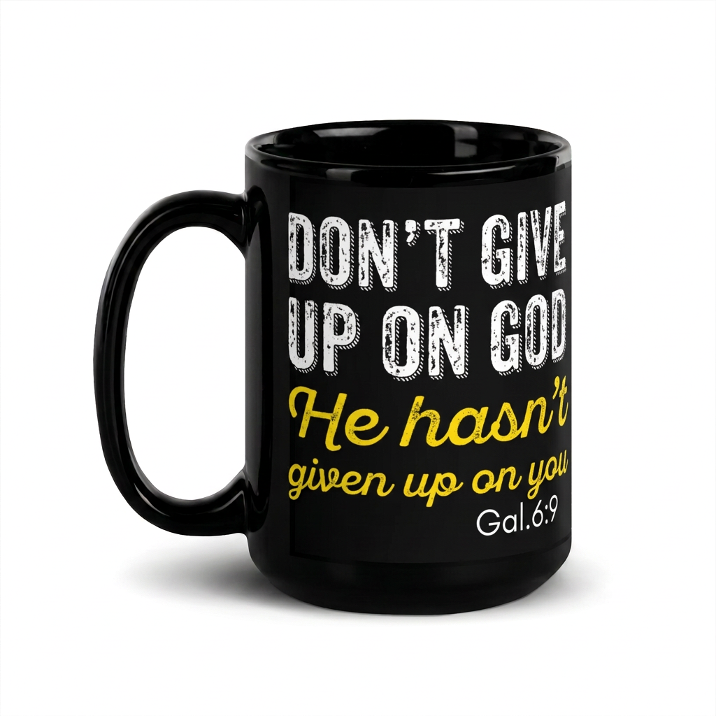 Black 15 oz mug reading Don't Give Up on God, He hasn't given up on us, Galatians 6:9, handle on left