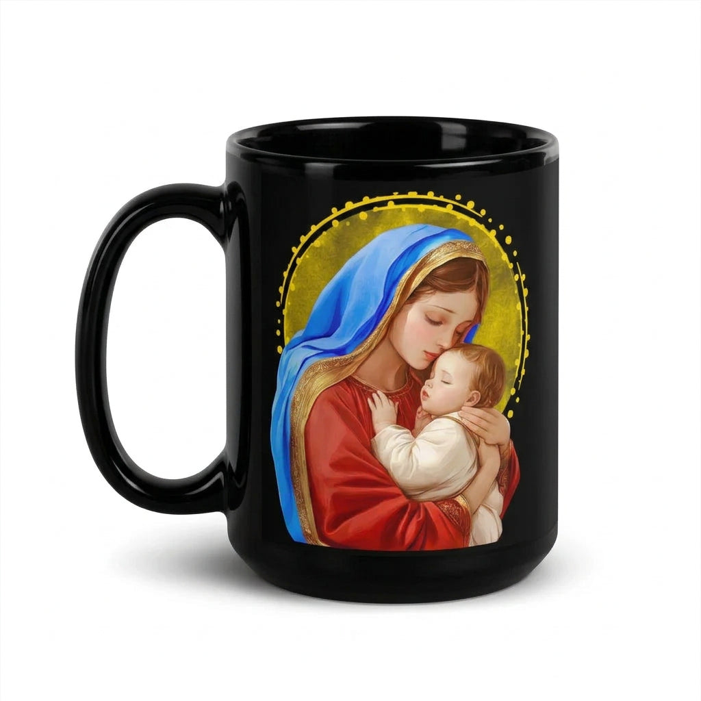 Glossy black mug showing Mary in a blue mantle holding Jesus against a golden background, handle on the left