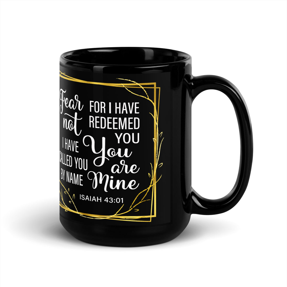 Angled view of a black Fear Not Isaiah 43:1 mug with a gold-colored leafy border, handle on right