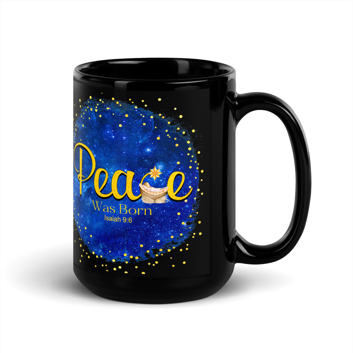 Black mug displaying gold Peace Was Born Isaiah 9:6 lettering with a manger and star against a blue background, handle on the right