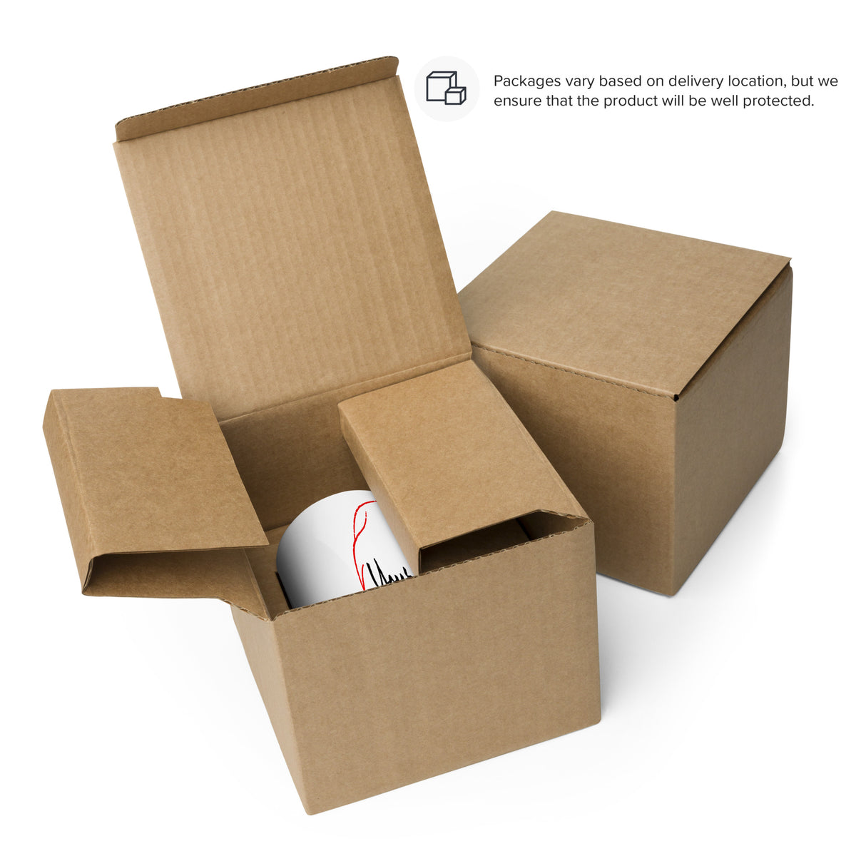White printed mug inside an open cardboard box beside a closed box