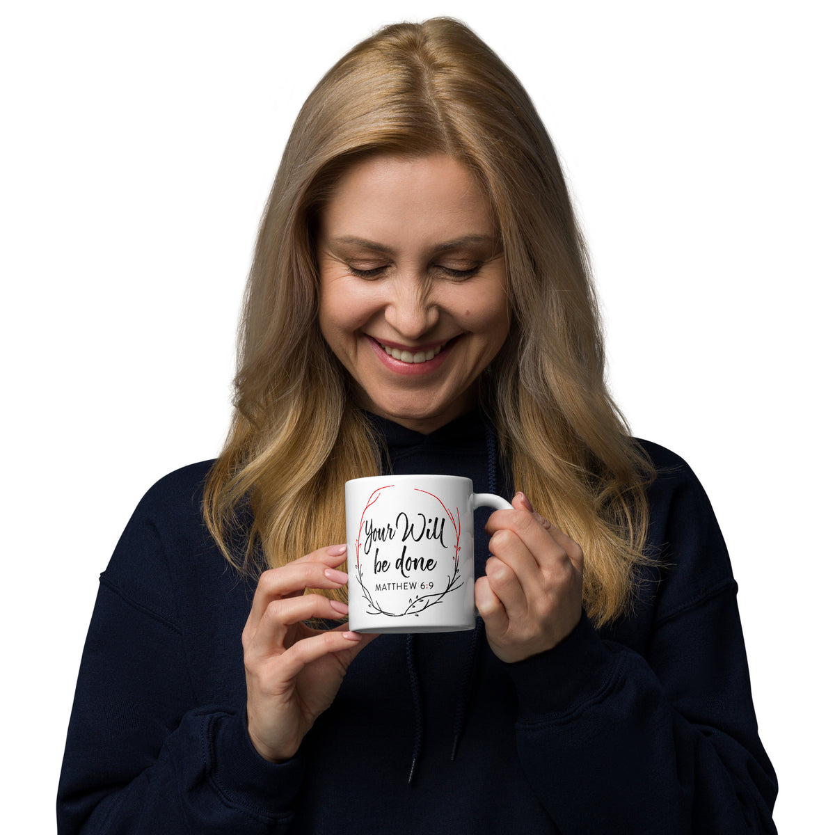 Woman holding a white Your Will Be Done wreath mug and looking down at it