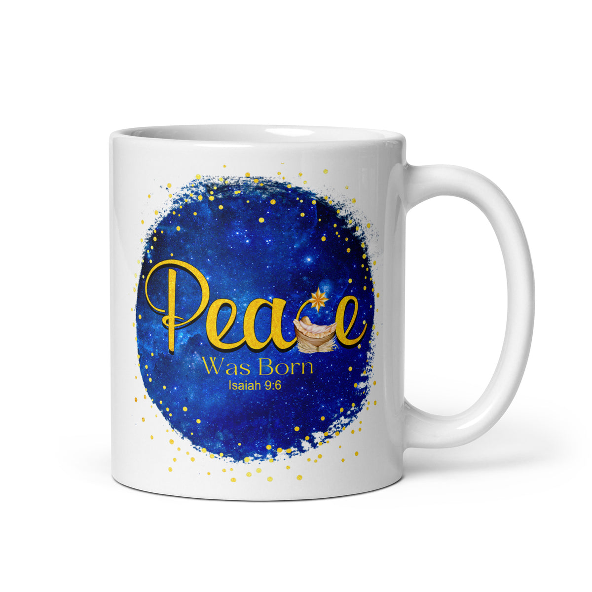 White mug with Peace Was Born Isaiah 9:6 lettering, a manger and star on a deep blue background, handle on the right