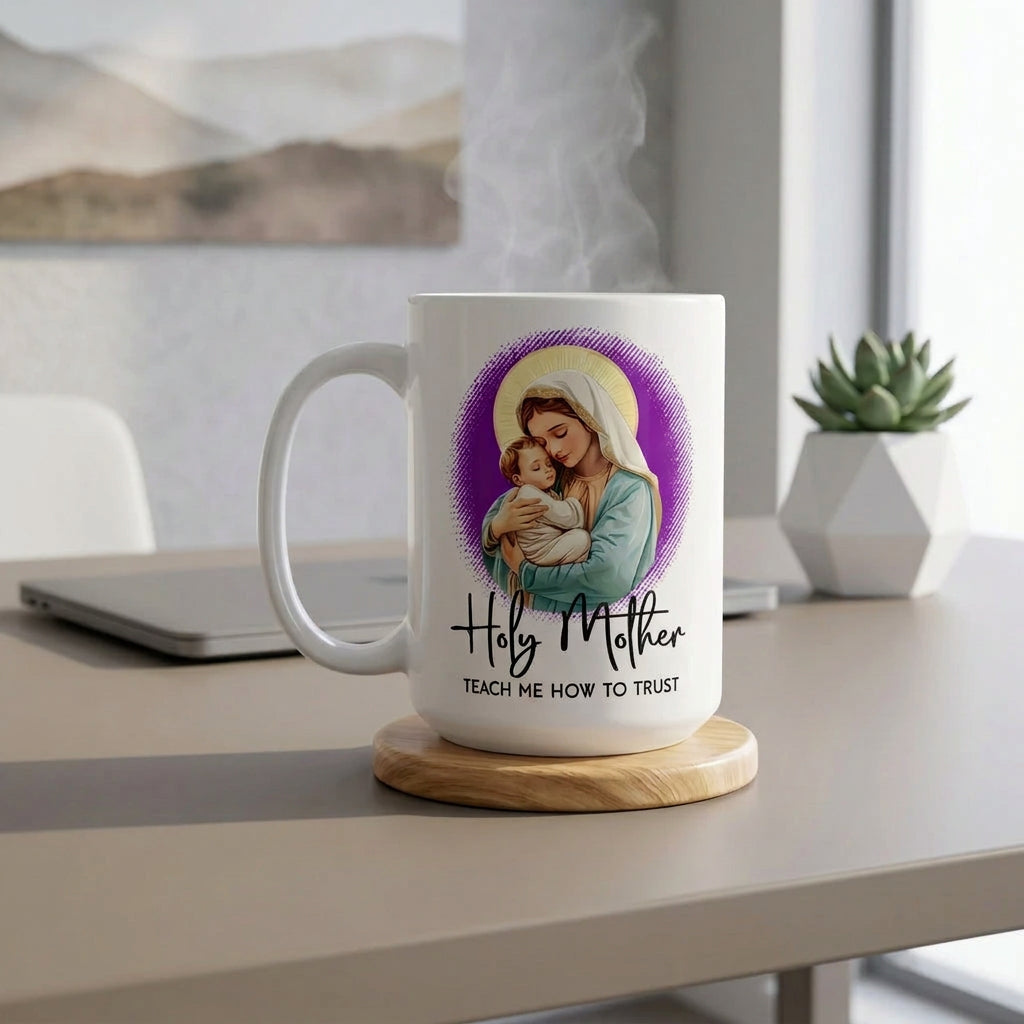 Steaming white Holy Mother Teach Me How to Trust mug on a wooden coaster beside a laptop and succulent, handle on the left