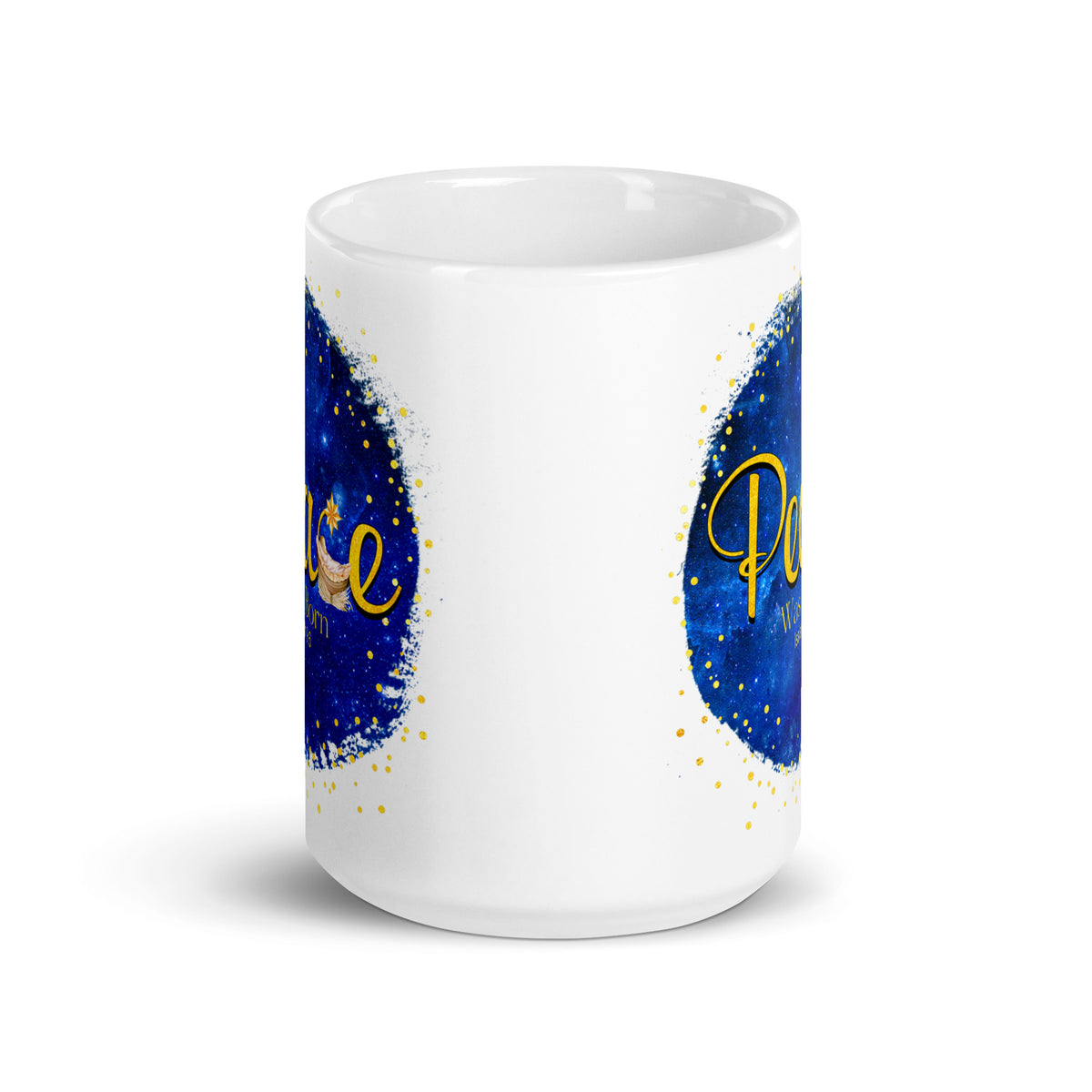 Side view of a white mug showing the edges of the blue and gold Peace Was Born design on both sides