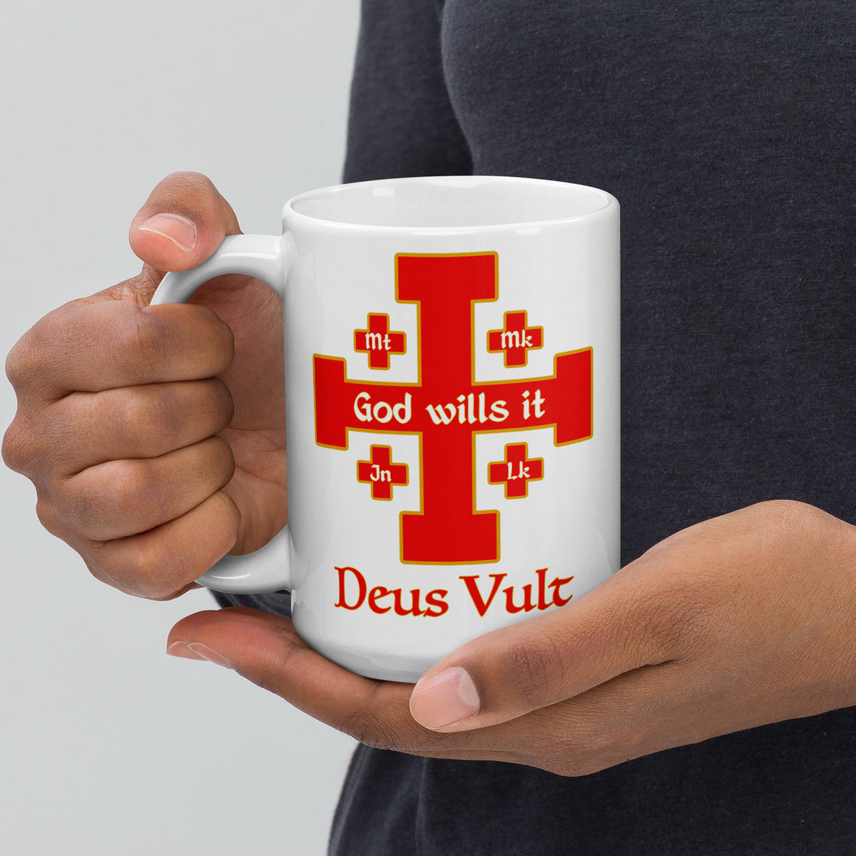 Person holding a white God Wills It Deus Vult cross mug in both hands