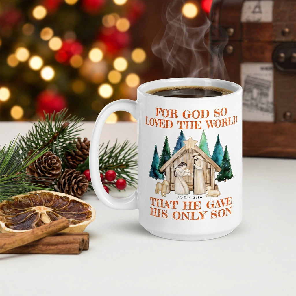 Steaming white John 3:16 nativity mug beside dried orange, cinnamon and evergreen branches, handle on the left