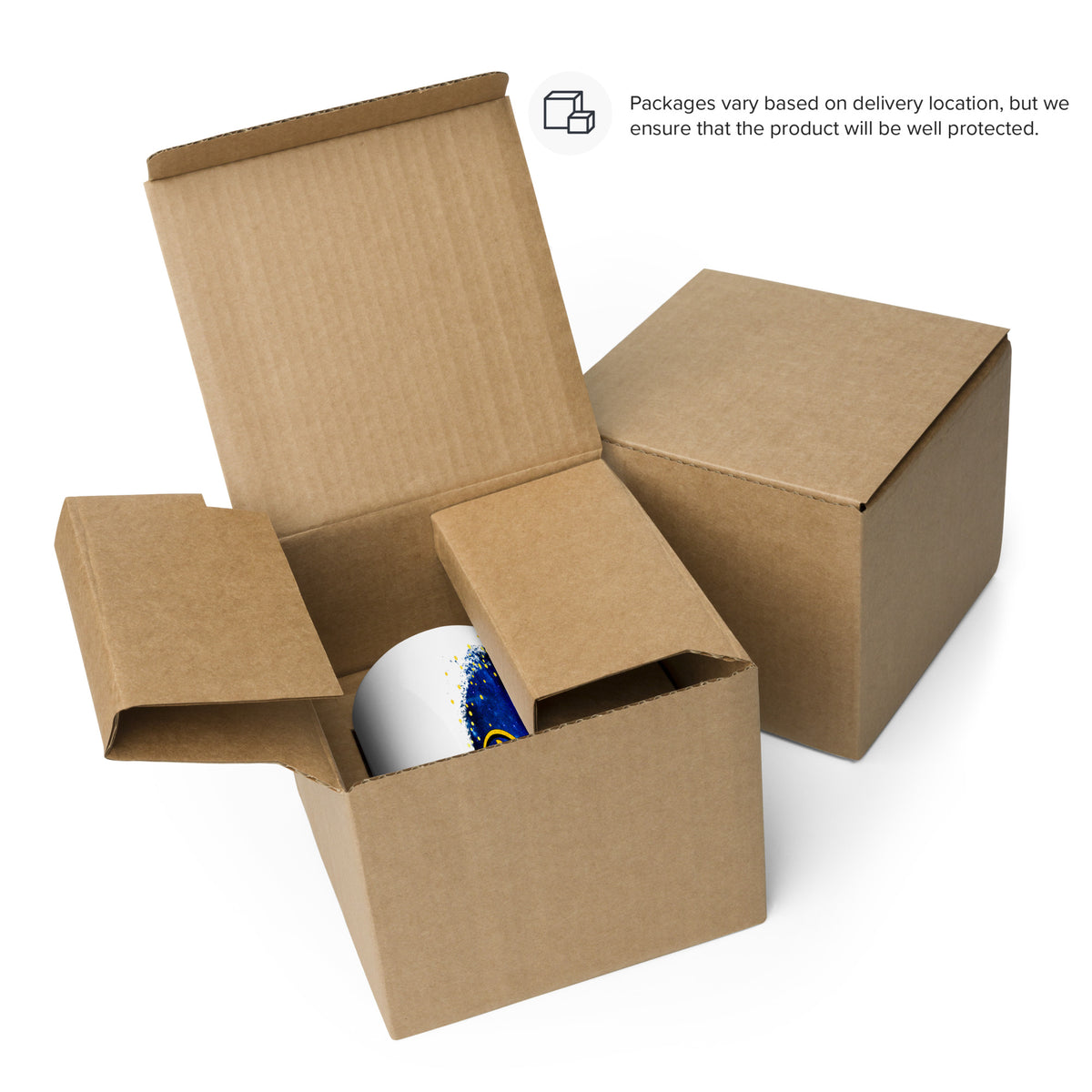 White Christmas mug inside an open cardboard box beside a closed box; packaging 