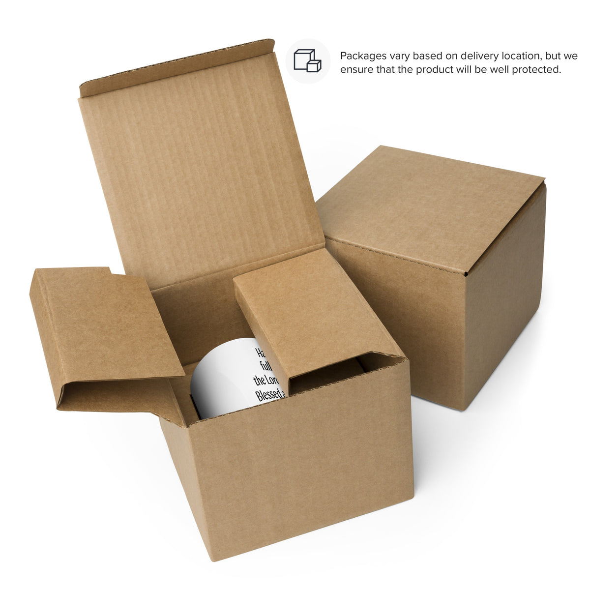 White prayer mug inside an open cardboard box beside a closed box; packaging 