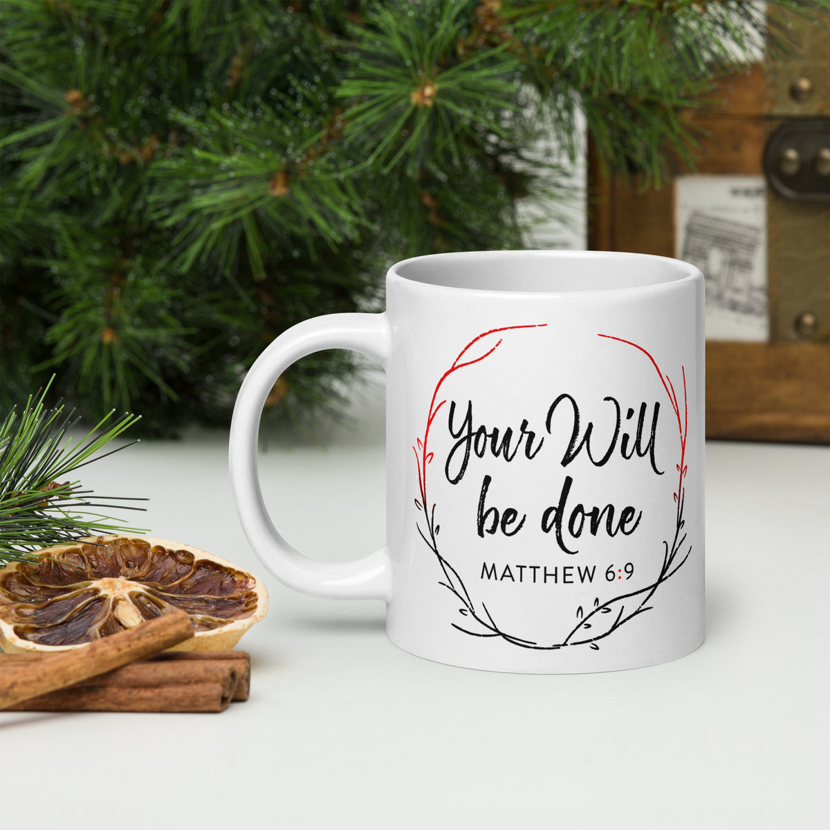 White Your Will Be Done wreath mug beside evergreen branches, dried citrus and cinnamon sticks