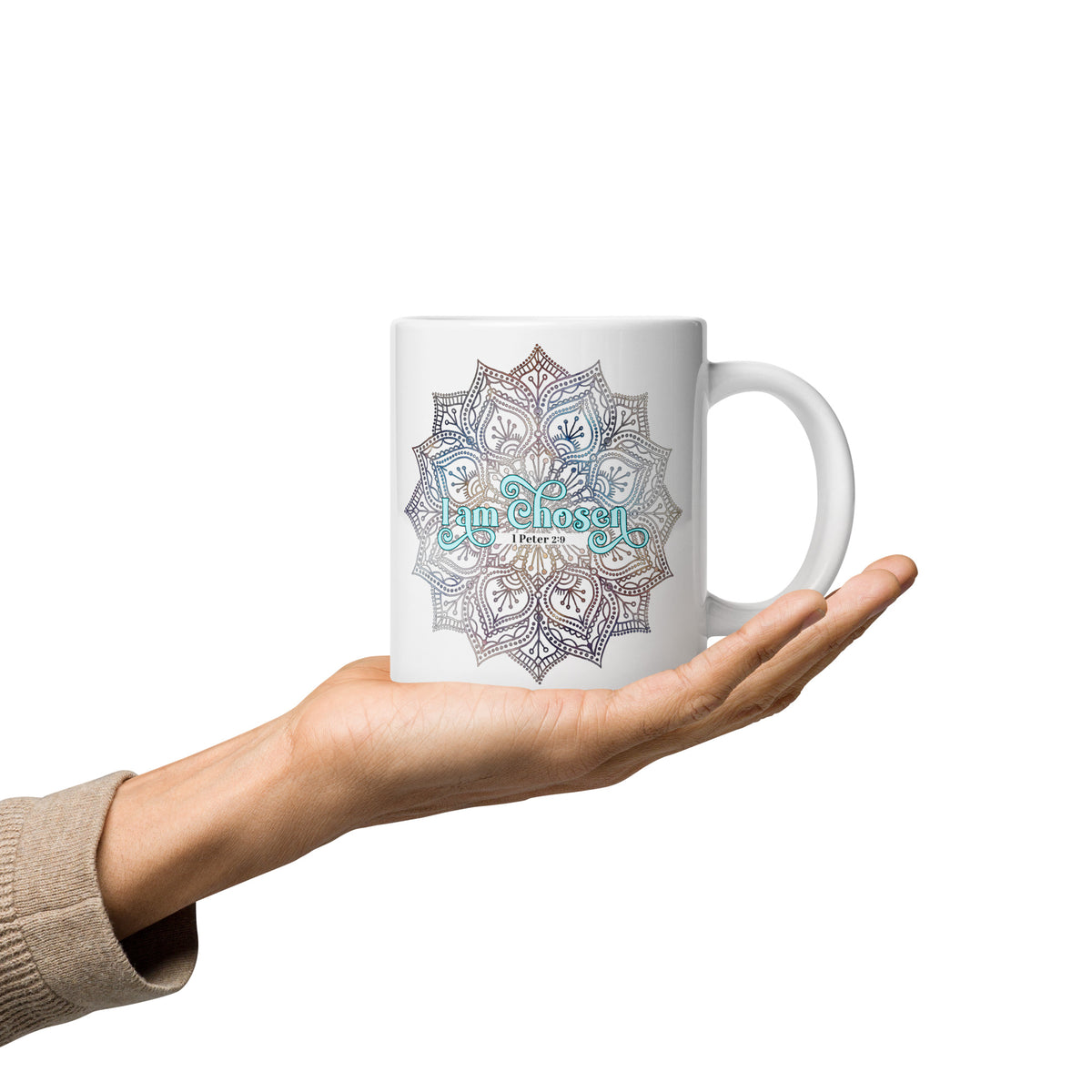 a hand holdingWhite glossy 20 oz mug with the I Am Chosen 1 Peter 2:9 design, handle on the right