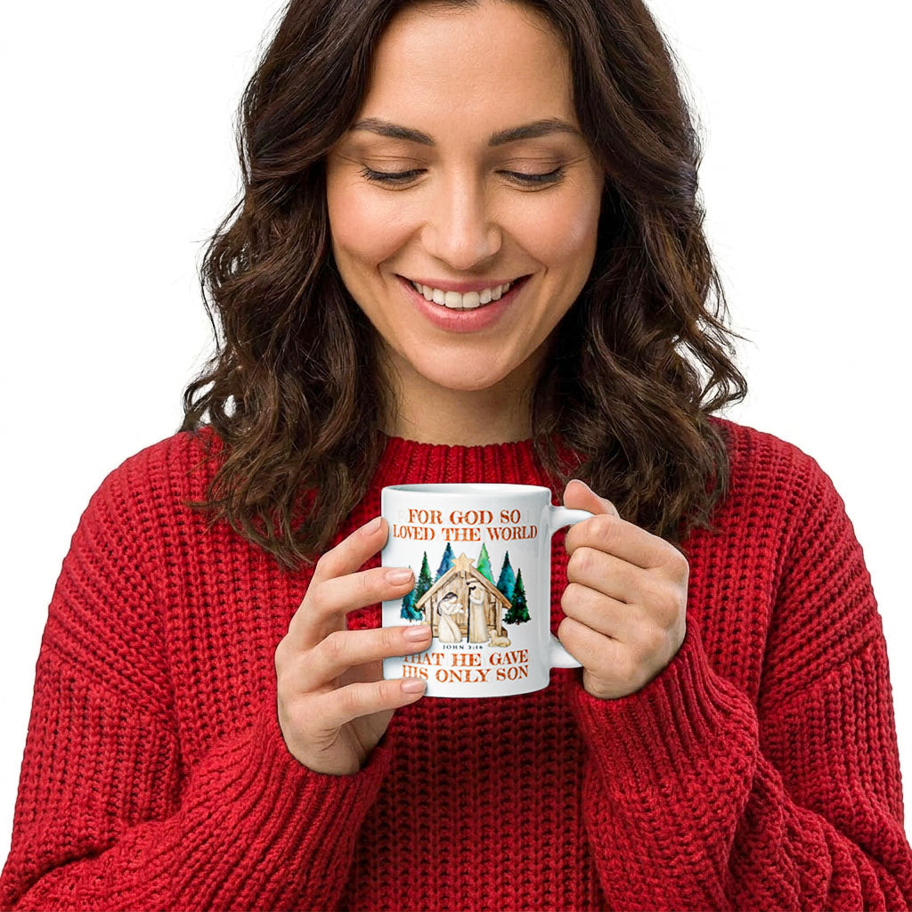 Woman in a red sweater holding a white John 3:16 nativity Christmas mug, handle on the right